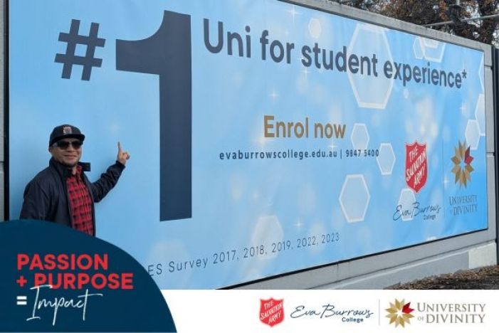 Registrar Norman in front of banner